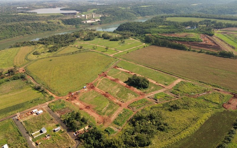 Vista aérea do miolo do loteamento, com as ruas de terra vermelha desenhando a malha das quadras.